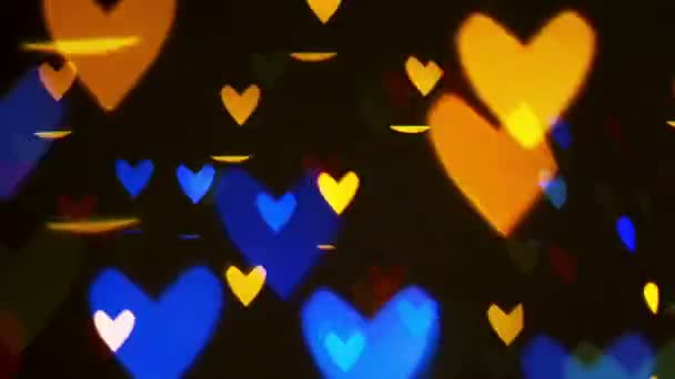 Colorido desenfocado parpadeo del corazón bokeh luces festivas — Vídeo de stock