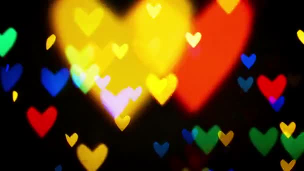 Colorful defocused blinking heart bokeh festive lights as abstract background — Stock Video