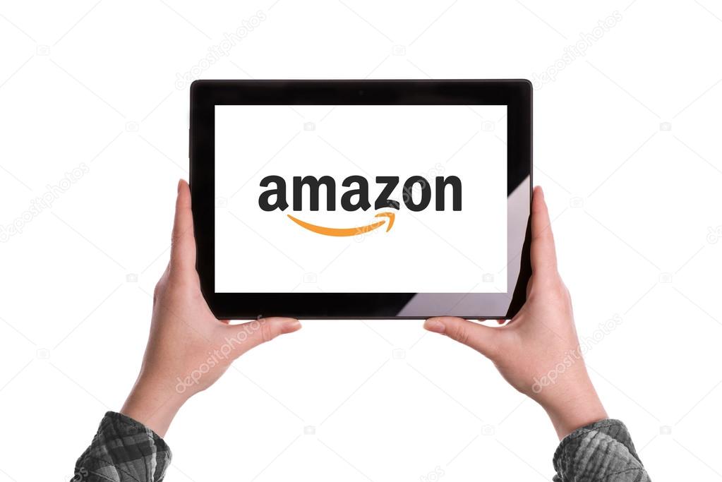 Novi Sad, Serbia - January 02, 2015: Hands Holding Digital Tablet Computer with Amazon Logo displayed on the screen. Illustrative editorial image isolated on white background.