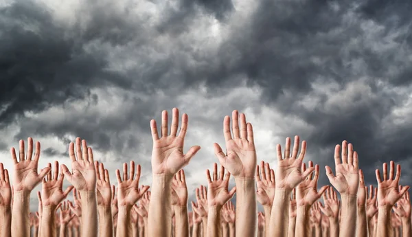 Hands raised in the air — Stock Photo, Image