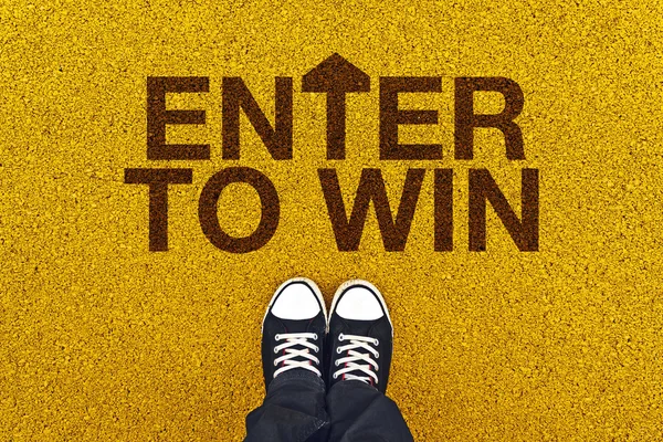 Enter to Win on Asphalt Road — стоковое фото