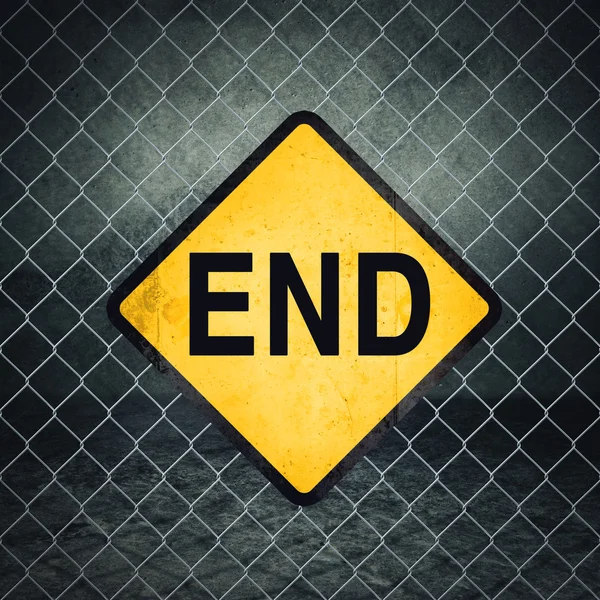 End Grunge Yellow Warning Sign on Chainlink Fence — Stock Photo, Image