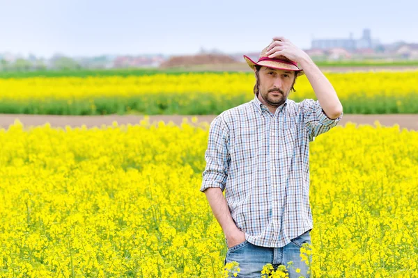 Farmer Standing in Oilseed Rapeseed Cultivated Agricultural Fiel