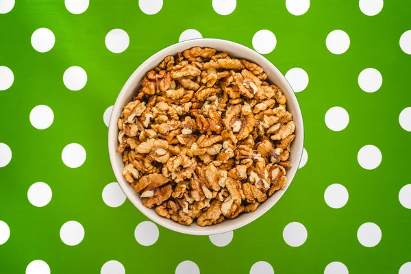 Walnut Kernels in Bowl on Polka Dotted Background — Stock Photo, Image