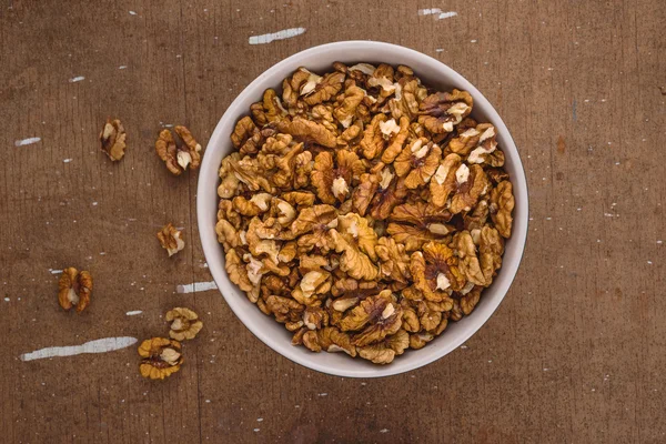 Walnut Kernels in Bowl on Brown Rustic Wood Plank Background — Stock Photo, Image