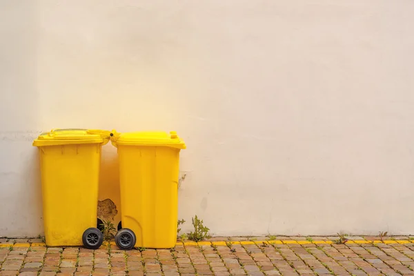 Dwie żółte recyklingu pojemników na ulicy — Zdjęcie stockowe