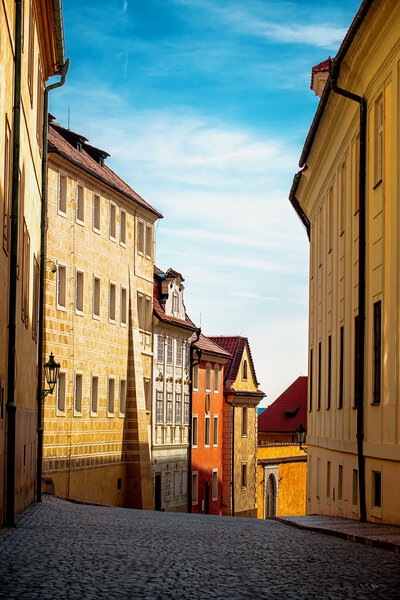 Empty Prague Street in Early Morning with Beautiful Old Facades and Blue Sky