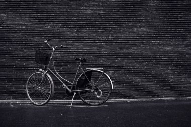 Classic vintage hipster retro bicycle leaning against the street