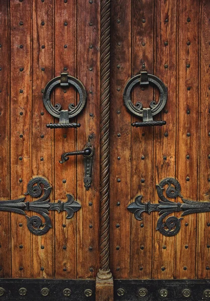 Old carved wooden door with hinges Royalty Free Stock Photos