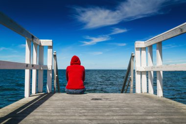 Alone Woman in Red Shirt at the Edge of Pier clipart