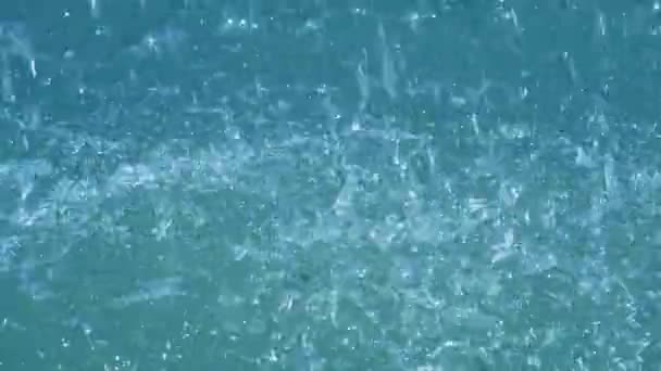 Heavy rain falling on water surface, water drops — Stock Video