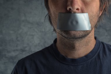 Censorship concept, man with duct tape on mouth