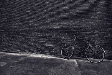 Classic vintage hipster bicycle leaning against the street wall
