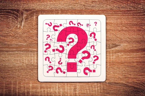 Question marks on jigsaw puzzle — Stok fotoğraf