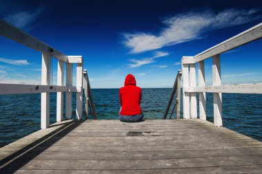 Alone Woman in Red Shirt at the Edge of Jetty clipart