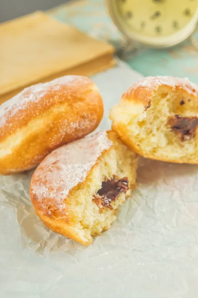 Sweet sugary donuts on rustic table — Stock Photo, Image