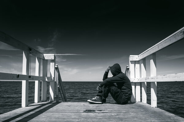 Alone Man at the Edge of Wooden Pier