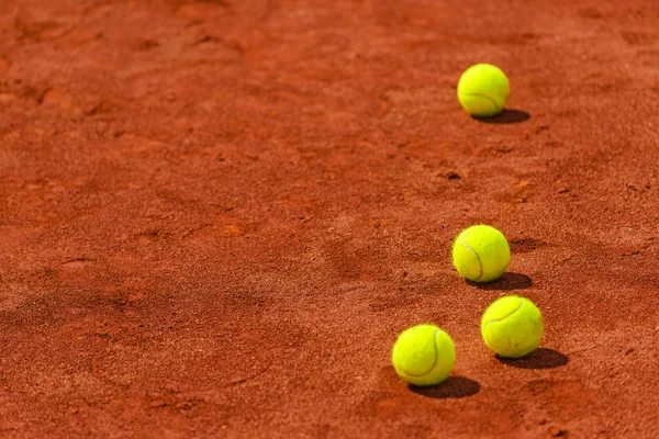 Tennis balls on clay court — Stock Photo, Image