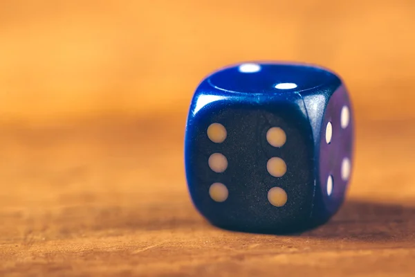 Blue dice on wooden table — Stock Photo, Image