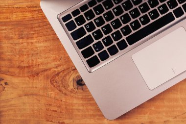 Laptop computer on rustic wooden office desk