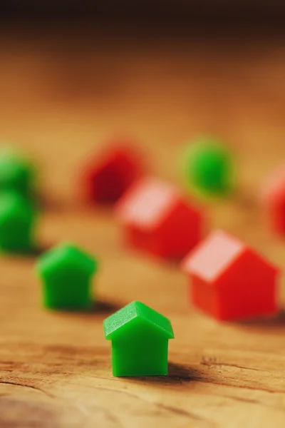 Plastic houses on wooden table — Stok fotoğraf