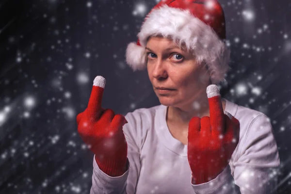 Beautiful woman in Santa Claus costume giving middle finger — Stock fotografie