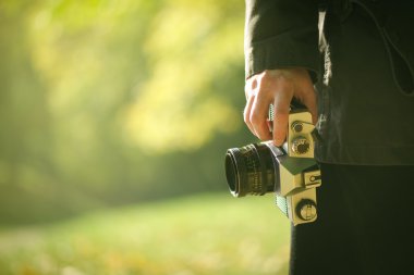 Hipster photographer exploring autumn nature landscapes