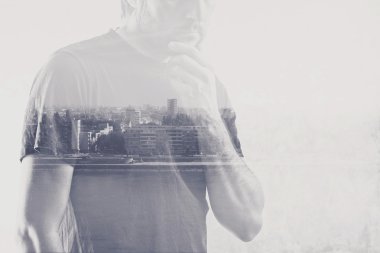 Double exposure of man thinking with hand on chin