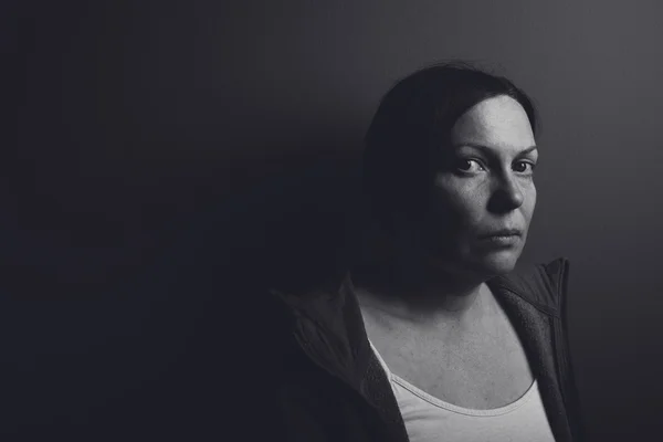 Intense low key portrait of pensive sad woman — Stock Photo, Image