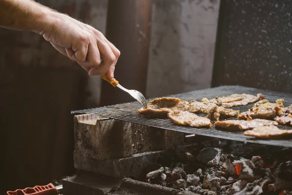 Man grilling pork meat chops on barbecue — Stock Photo, Image