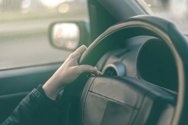 Female driver hands griping steering wheel — Stock Photo, Image