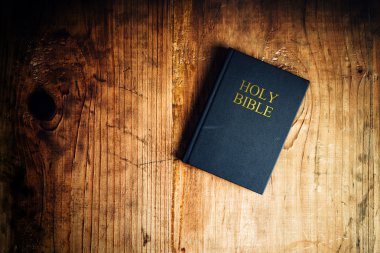 Holy bible on table clipart