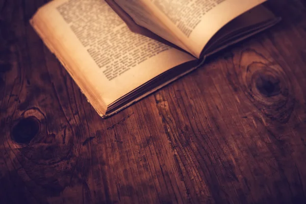 Old book on library desk — Stock Photo, Image