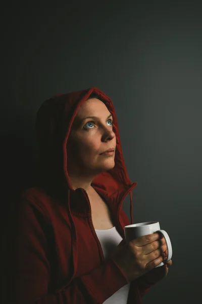 Linda mulher solitária com capuz vermelho bebendo café — Fotografia de Stock