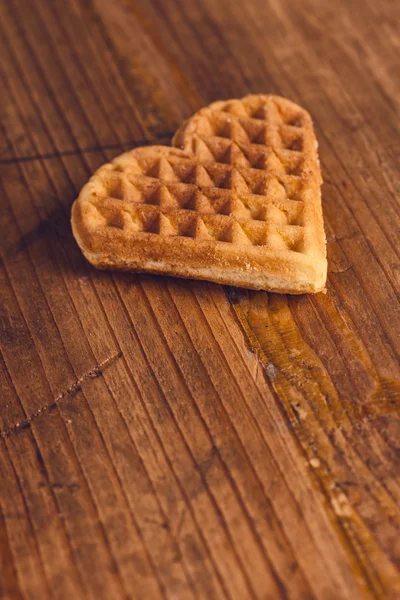 Heart shaped homemade waffle on wooden desk — Stock Photo, Image