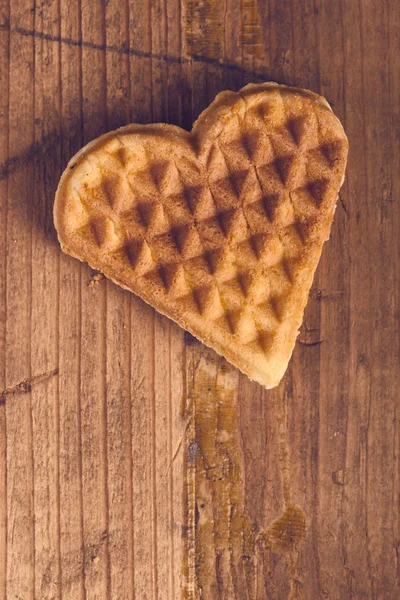 Heart shaped homemade waffle on wooden desk — Stock Photo, Image