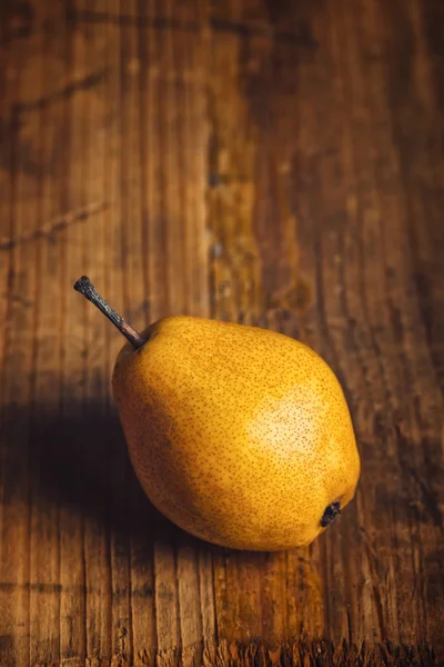 Yellow pear on wooden table — Stock Photo, Image