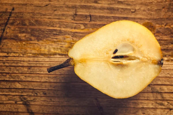 Yellow pear sliced on wooden table — Stock Photo, Image