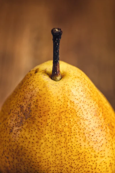 Yellow pear on wooden table — Stock Photo, Image