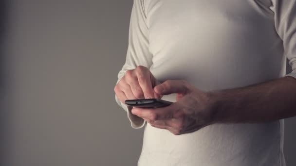 Casual male using mobile smartphone having stomachache — Stock Video