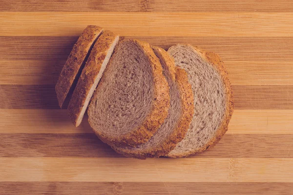 Slices of buckwheat bread on cutting board, top view — Stock Photo, Image