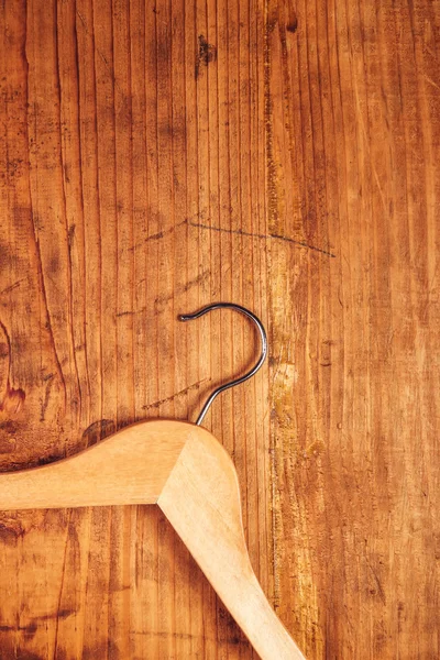 Retro cloth hanger on rustic wooden background, top view — Stockfoto
