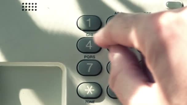 Man dialing random numbers on landline telephone pad — Stock Video