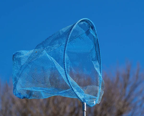 Butterfly net over blue sky. — Stock Photo, Image