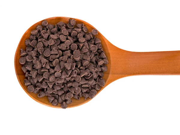 Choc chips for baking on wooden spoon, isolated over white — Stock Photo, Image