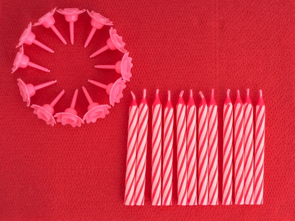 Birthday cake candles, unlit on red serviette aka napkin background — Stock Photo, Image