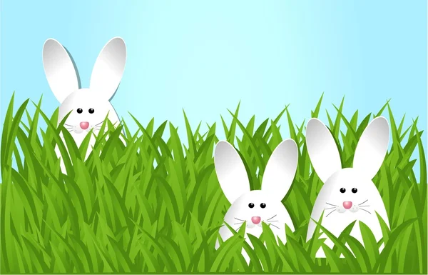 Conejitos de Pascua en la hierba — Vector de stock