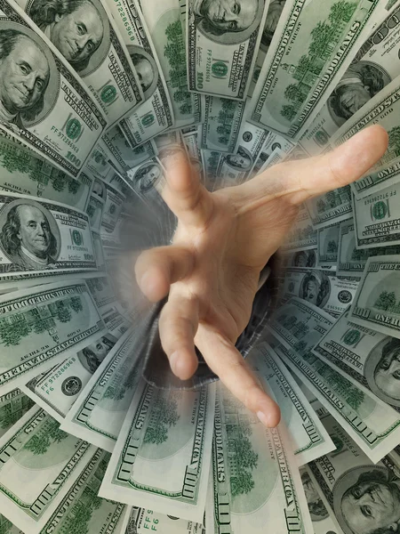 Businessman hand drowning in money hole (Shallow DOF) — Stock Photo, Image