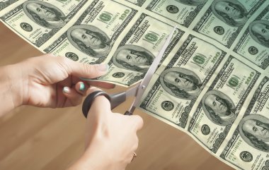 Woman cuts Dollars (credit concept) clipart