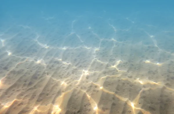 Tiro subaquático de um fundo do mar arenoso infinito — Fotografia de Stock